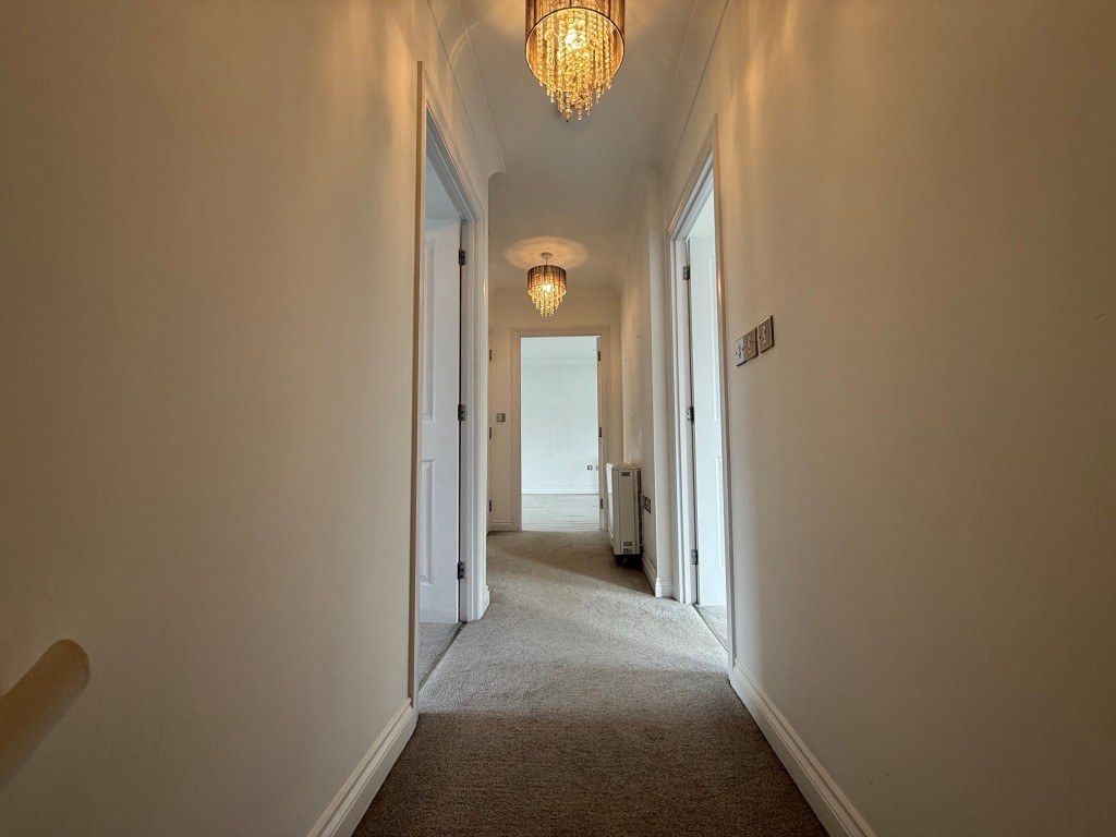 Lot: 64 - THREE-BEDROOM SPLIT LEVEL MAISONETTE - Hallway with doors to accommodation